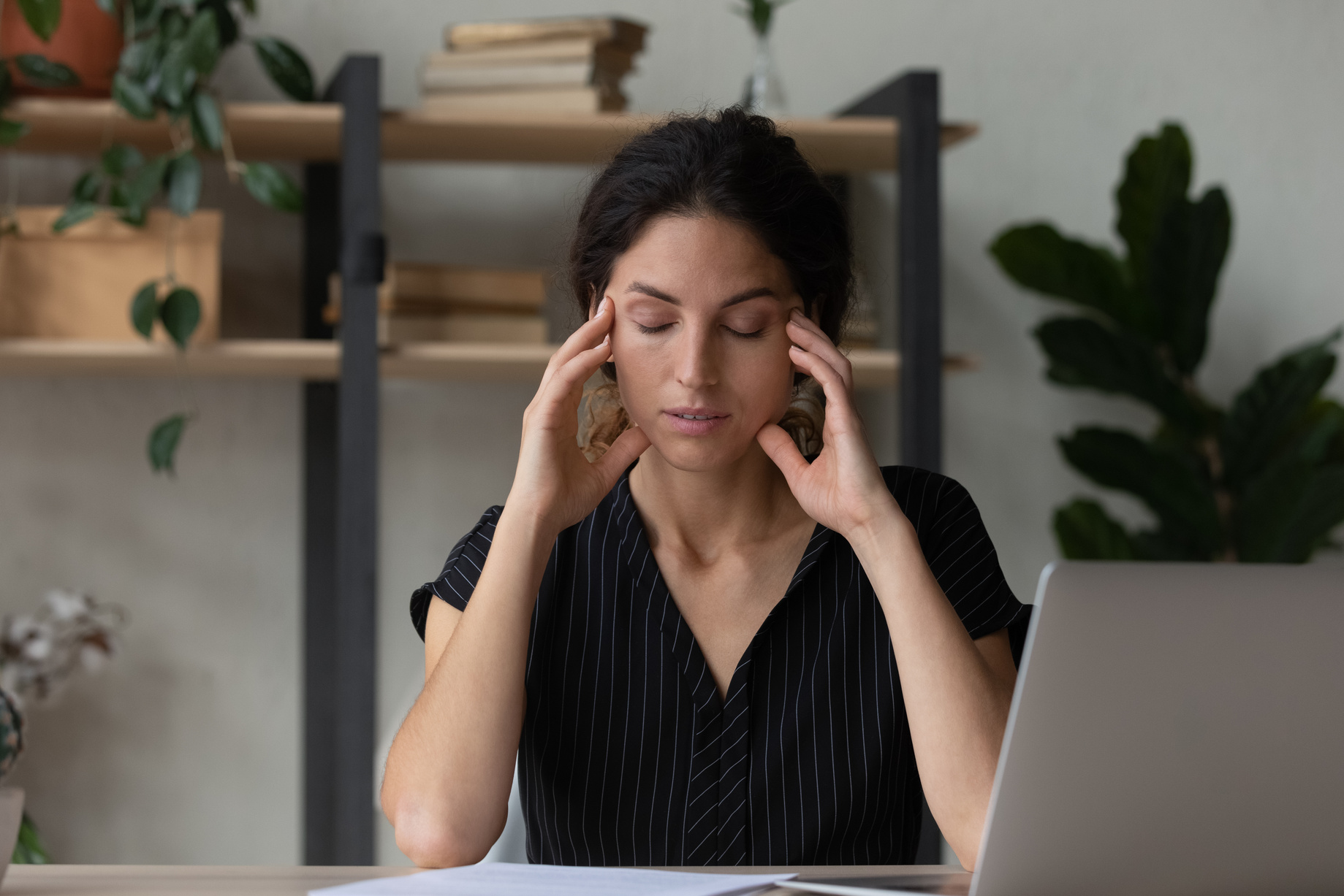 Tired young woman overwhelmed with computer work